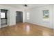 Living room with beautiful wood floors and natural light from two windows at 5919 Mcenroe Ct, Leesburg, FL 34748