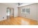 Open living room featuring wood floors and sliding glass doors at 5919 Mcenroe Ct, Leesburg, FL 34748