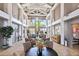 Grand lobby with high ceilings, elegant lighting, cozy seating, artwork, and tile flooring at 5919 Mcenroe Ct, Leesburg, FL 34748