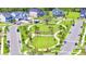 A vibrant community features well-maintained lawns, sidewalks, and a central park area with lush greenery and inviting walkways at 6494 Rover Way, St Cloud, FL 34771