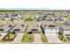 A neighborhood with many houses that have solar panels on their roofs shows well-maintained lawns and community spaces at 6494 Rover Way, St Cloud, FL 34771