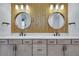 Bathroom featuring double sinks, wood accent wall, and modern fixtures at 6494 Rover Way, St Cloud, FL 34771