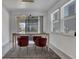 Dining area with modern lighting, rug, and three red velvet chairs with a view of the outside at 6494 Rover Way, St Cloud, FL 34771