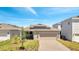 New home featuring solar panels, a brick-paver driveway, a well-maintained lawn, and an attached garage at 6494 Rover Way, St Cloud, FL 34771