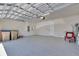 Spacious garage with epoxy flooring, overhead lighting, and ample room for parking and storage at 6494 Rover Way, St Cloud, FL 34771