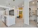 Bright, open kitchen area with modern appliances and a view towards the living room and pantry at 6494 Rover Way, St Cloud, FL 34771