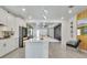 Modern kitchen featuring white cabinets, stainless steel appliances, large island and unique lighting at 6494 Rover Way, St Cloud, FL 34771