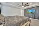Bedroom with a ceiling fan and television mounted on an accent wall at 6494 Rover Way, St Cloud, FL 34771