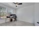 Bright home office with a ceiling fan, large window for natural light, and wood-look tile floors at 6494 Rover Way, St Cloud, FL 34771