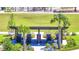 Overhead view of a community park with a picnic area, palm trees, landscaping and a manicured lawn at 6494 Rover Way, St Cloud, FL 34771