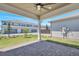 Covered patio with brick pavers offering outdoor living and a view of the well-maintained community at 6494 Rover Way, St Cloud, FL 34771