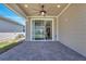 Covered patio with brick pavers, a ceiling fan, and sliding glass doors leading to the interior at 6494 Rover Way, St Cloud, FL 34771