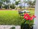 Landscaped backyard with seating area among palm trees at 6617 Harper Way, Harmony, FL 34773