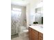 Bathroom with a tub and shower with an updated shower curtain and new cabinets at 6617 Harper Way, Harmony, FL 34773