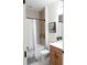 Bathroom featuring a shower with beige tiles, a toilet, and a vanity with a wooden cabinet at 6617 Harper Way, Harmony, FL 34773
