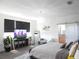 Bright bedroom with a modern design, plush carpet, and a sleek entertainment center at 6617 Harper Way, Harmony, FL 34773