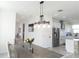 Dining area open to a kitchen with stainless steel appliances and modern finishes at 6617 Harper Way, Harmony, FL 34773