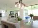 Open-concept with modern light fixture, access to outdoor patio, fireplace, and tv view at 6617 Harper Way, Harmony, FL 34773