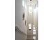 Bright entryway featuring a modern light fixture, unique wall art, and an open staircase, creating an inviting space at 6617 Harper Way, Harmony, FL 34773