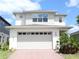 Charming two-story home with a brick driveway, large garage, and well-maintained landscaping at 6617 Harper Way, Harmony, FL 34773