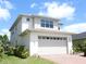Contemporary two-story home with a spacious garage and well-manicured landscaping at 6617 Harper Way, Harmony, FL 34773