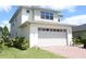Modern two-story home with a two-car garage, brick driveway, and well-maintained landscaping at 6617 Harper Way, Harmony, FL 34773