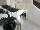 Inviting hallway with tile floors leading to an open dining area and staircase at 6617 Harper Way, Harmony, FL 34773