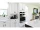Modern kitchen featuring white cabinets, stainless steel appliances, and sleek countertops at 6617 Harper Way, Harmony, FL 34773