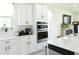 Modern kitchen featuring white cabinets, stainless steel appliances, and sleek countertops at 6617 Harper Way, Harmony, FL 34773