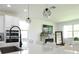Bright kitchen with a large island, stainless steel appliances, and modern lighting at 6617 Harper Way, Harmony, FL 34773