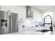 Bright kitchen featuring white cabinets, stainless steel appliances, and subway tile backsplash at 6617 Harper Way, Harmony, FL 34773