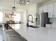 Bright kitchen with a large island, stainless steel appliances, and modern fixtures at 6617 Harper Way, Harmony, FL 34773