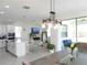 Spacious kitchen featuring an island with seating and views of the living and dining areas at 6617 Harper Way, Harmony, FL 34773