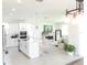 Open-concept kitchen with large center island, breakfast bar, and view of the fireplace at 6617 Harper Way, Harmony, FL 34773