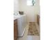 Bright laundry room features modern washer and dryer, plus counter space and shelving at 6617 Harper Way, Harmony, FL 34773