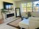 Bright living room features a stone fireplace and large windows at 6617 Harper Way, Harmony, FL 34773