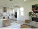 An open-concept living space featuring a fireplace, kitchen, and dining area with modern finishes and an abundance of natural light at 6617 Harper Way, Harmony, FL 34773