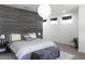 Inviting main bedroom with accent wall, contemporary lighting, and neutral tones, offering a peaceful ambiance at 6617 Harper Way, Harmony, FL 34773