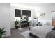 Bright main bedroom with a flat screen TV, walk in closet, and grey and white decor at 6617 Harper Way, Harmony, FL 34773