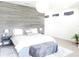 Serene main bedroom with an accent wall, contemporary decor, and ample natural light, creating a relaxing retreat at 6617 Harper Way, Harmony, FL 34773