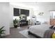 Bright main bedroom with a flat screen TV, walk in closet, and grey and white decor at 6617 Harper Way, Harmony, FL 34773