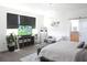 Bright main bedroom with a TV, seating, and access to a bathroom, creating a comfortable and functional space at 6617 Harper Way, Harmony, FL 34773