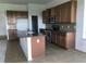 Spacious kitchen features granite countertops, an island, and modern stainless steel appliances at 6806 Trellis Vine Loop, Windermere, FL 34786