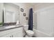 Bright bathroom featuring a shower-tub combo, white cabinets, and a grey countertop at 721 Drop Shot Dr, Davenport, FL 33896
