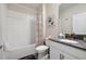 Bright bathroom featuring a shower-tub combo, white cabinets, and a grey countertop at 721 Drop Shot Dr, Davenport, FL 33896