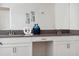 Close-up of a bathroom vanity with double sinks, white cabinets, and a grey countertop at 721 Drop Shot Dr, Davenport, FL 33896