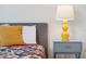 Close-up of the bed with yellow bedside lamp at 721 Drop Shot Dr, Davenport, FL 33896