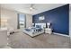 Serene bedroom with a navy accent wall, plush carpet, and a comfortable queen-size bed at 721 Drop Shot Dr, Davenport, FL 33896