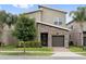 Beautiful townhome with manicured lawn, paved walkway, lovely stone details, and a nice shade tree at 721 Drop Shot Dr, Davenport, FL 33896