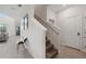 Inviting hallway with staircase, tiled flooring, and modern decor leading to the living area at 721 Drop Shot Dr, Davenport, FL 33896